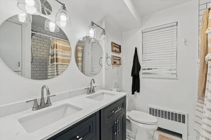 Double vanity with integrated sinks, brushed nickel fixtures, and dark wood cabinetry