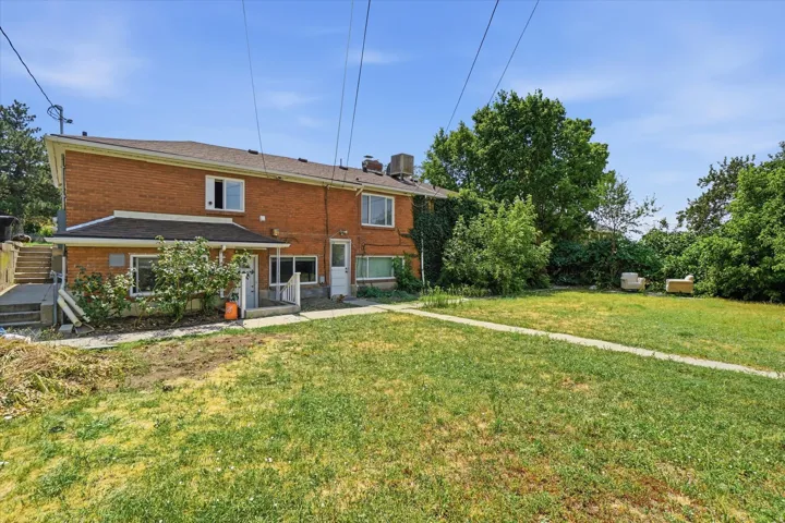 Brick exterior with a covered patio and a separate entry door