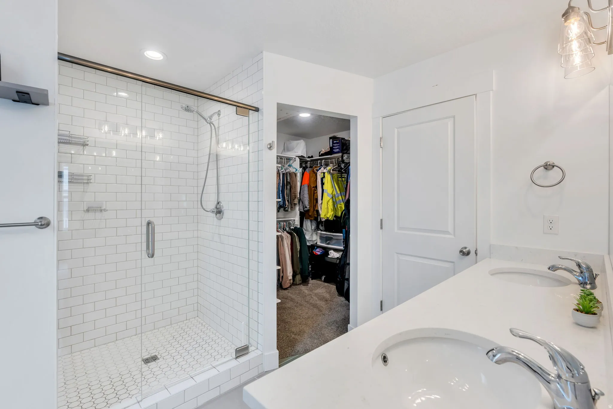 Walk-in shower with subway tile surround and glass enclosure