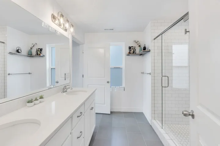 White vanity with dual integrated sinks and a spacious countertop