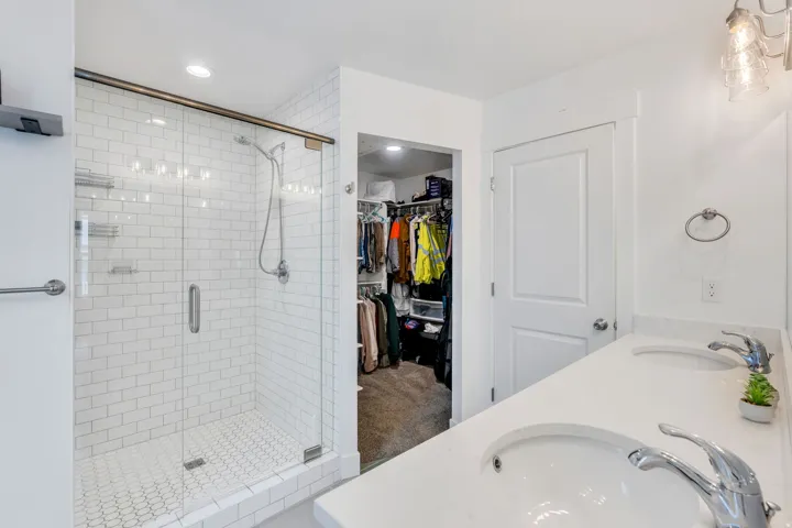 Walk-in shower with subway tile surround and glass enclosure