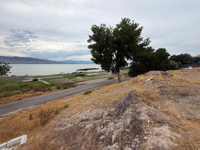 Expansive water frontage with a paved road running parallel to the shoreline