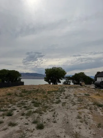 Expansive cleared lot featuring a natural landscape and distant water frontage