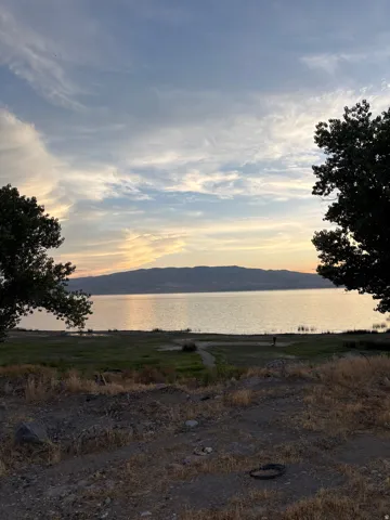 Expansive waterfront setting with distant mountains and a broad body of water