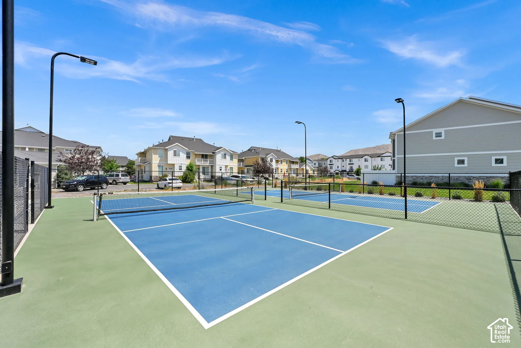 Multiple pickleball courts featuring blue and green surfacing
