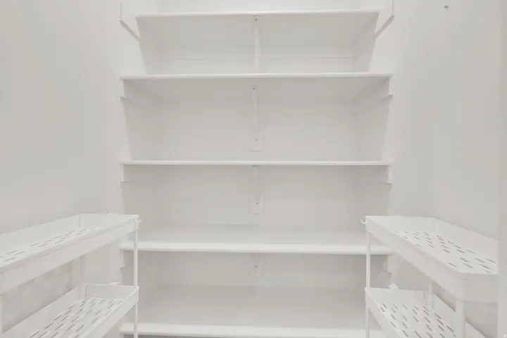 Built-in white shelving system featuring multiple tiers