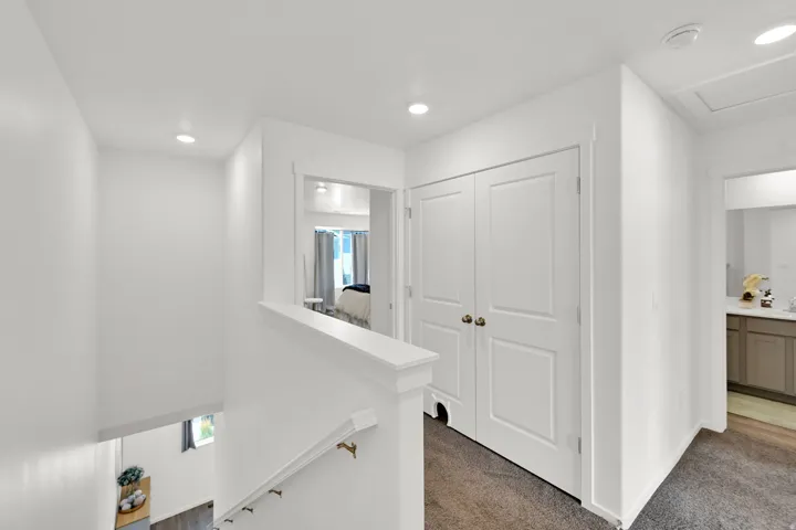 Upper landing featuring recessed lighting, a neutral color palette, and carpet flooring