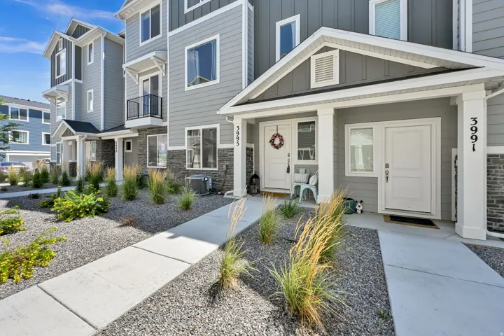 Modern townhome exterior featuring gray siding and stone accents