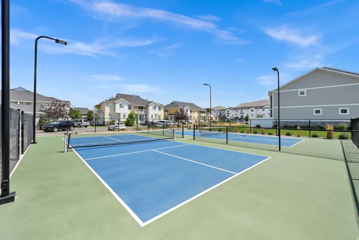 Multiple pickleball courts featuring blue and green surfacing