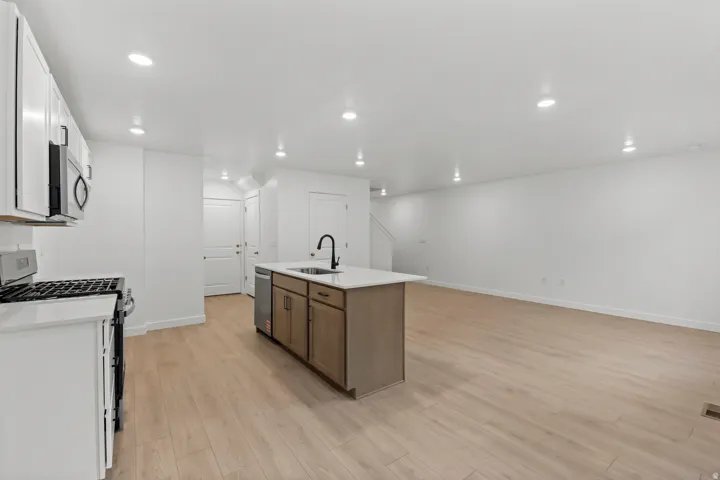 Open-concept living space featuring wood-finish flooring and recessed lighting