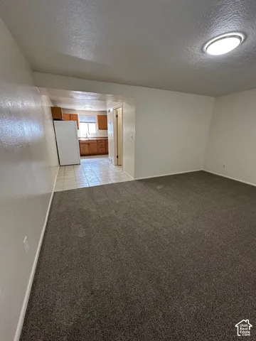 Spacious room featuring new carpeting, recessed ceiling lighting, and neutral wall tones