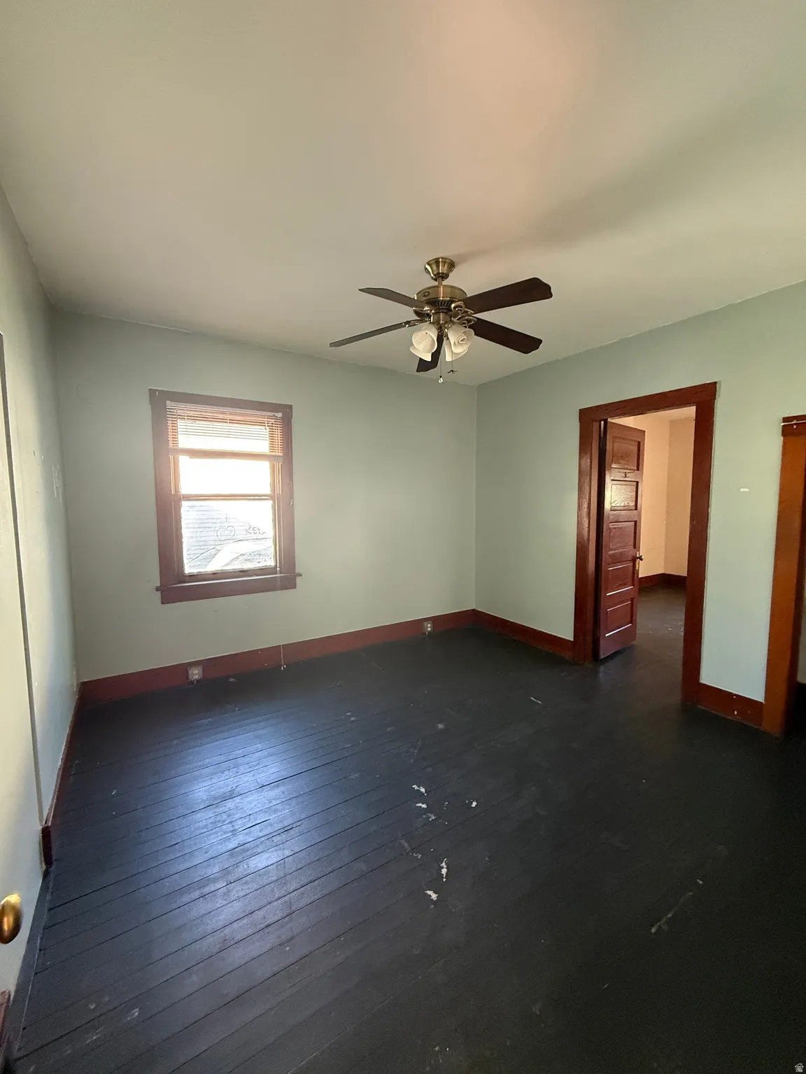 Room featuring dark wood-finish flooring and light-toned walls