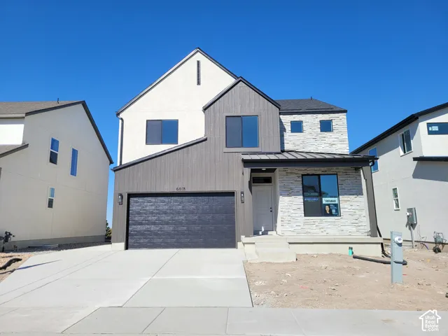 Multi-textured facade featuring horizontal siding and stacked stone accents