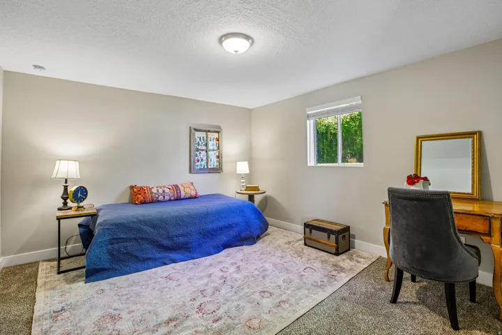 Carpeted room with a single window and recessed lighting