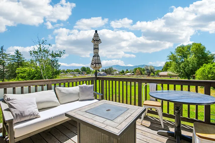 Expansive outdoor deck featuring wood-finish flooring and a wood railing