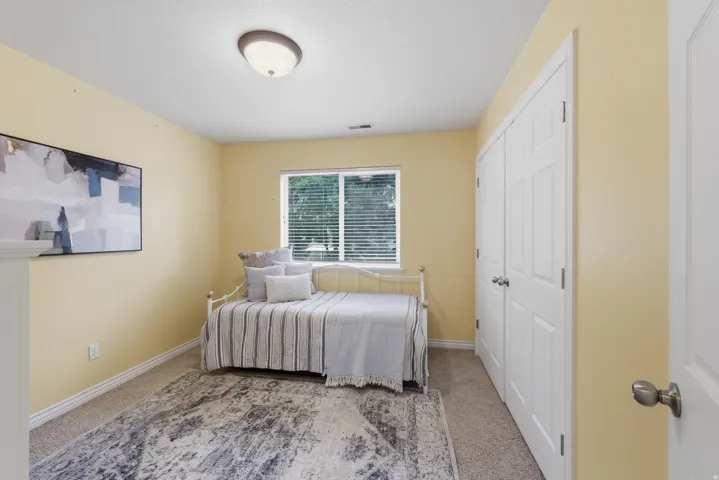 Carpeted room with light yellow walls and white trim