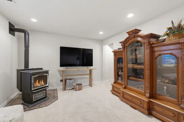 Built-in wood-burning stove with a tile hearth and a visible exhaust pipe