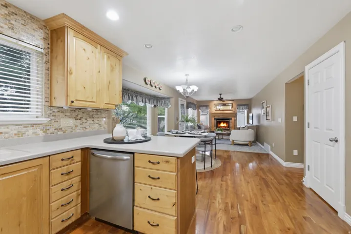 Kitchen featuring wood cabinetry, light-toned countertops, and a mosaic tile backsplash