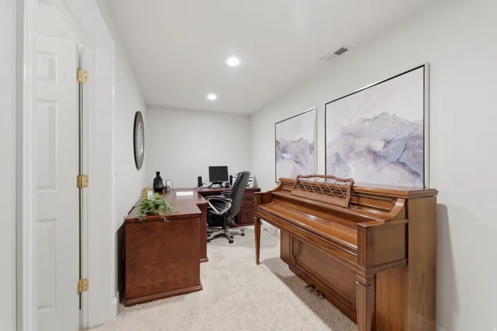 Carpeted room with recessed lighting and light gray walls