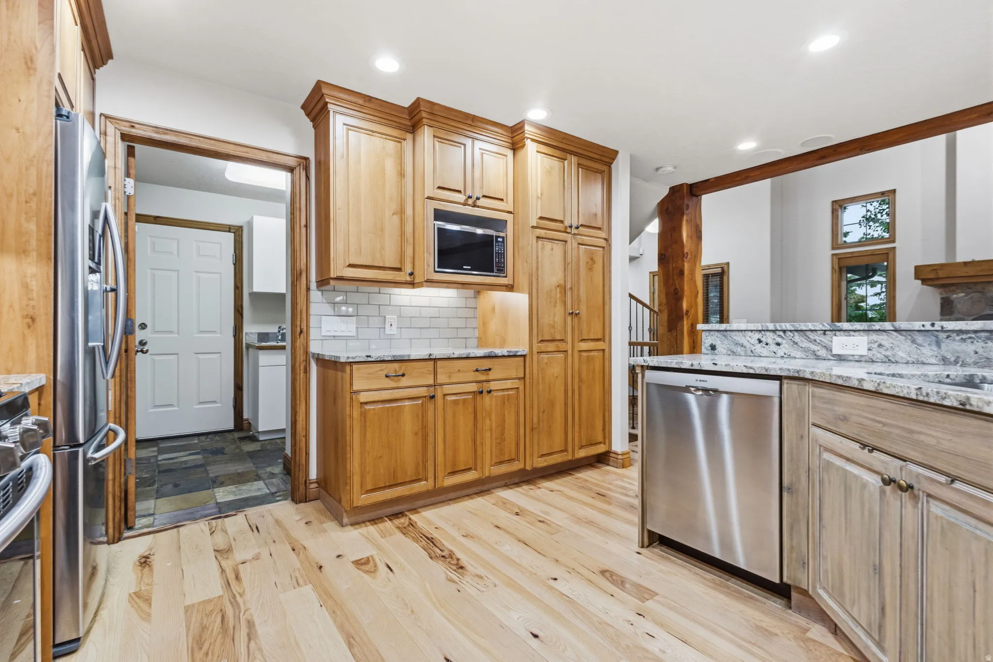 Kitchen featuring light wood-finish flooring and solid wood cabinetry