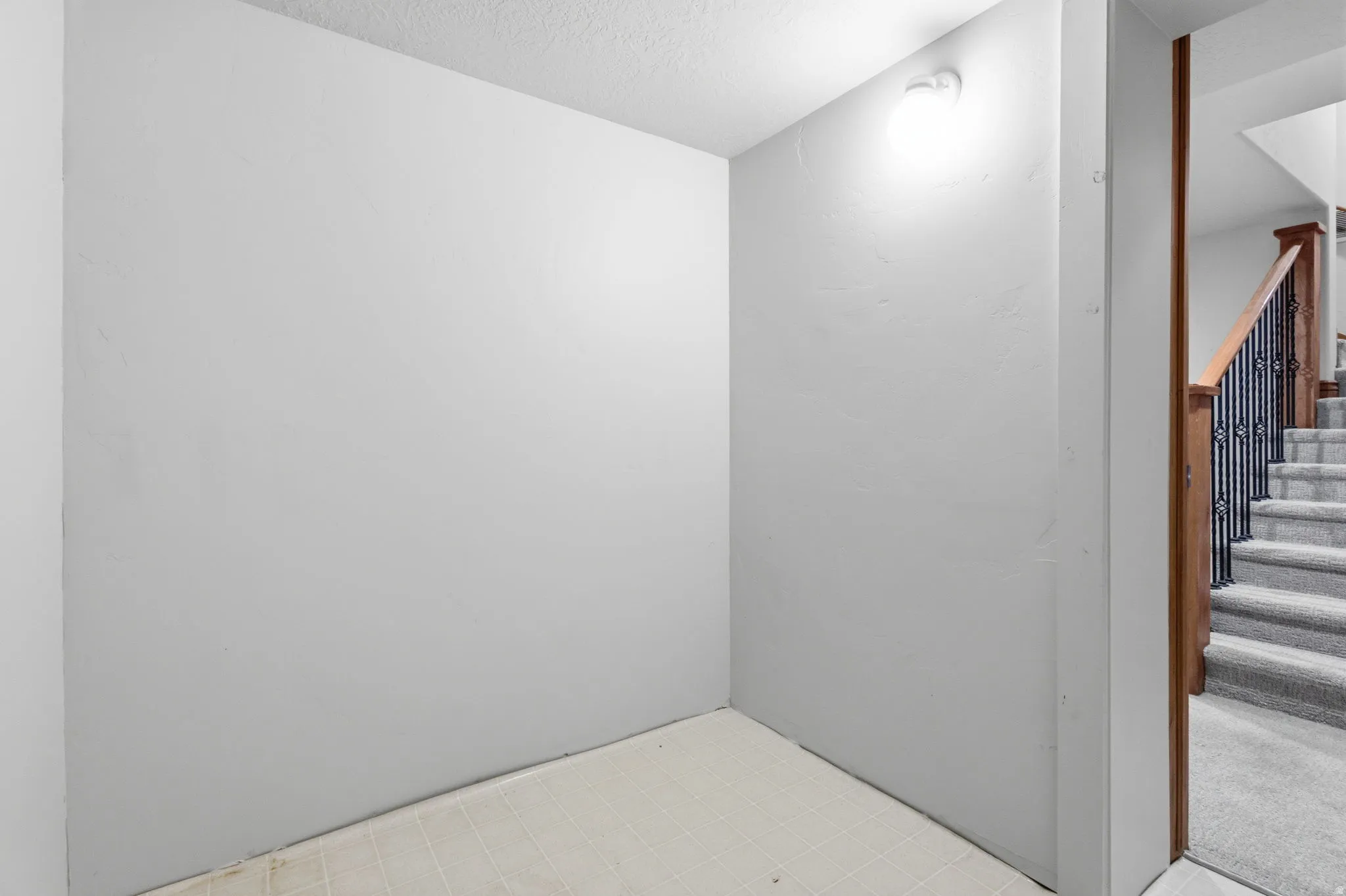 Recessed wall alcove featuring white painted walls and light-colored flooring