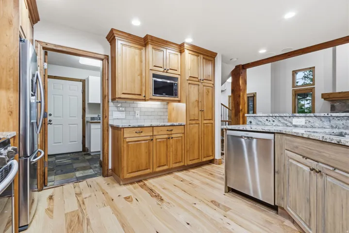 Kitchen featuring light wood-finish flooring and solid wood cabinetry
