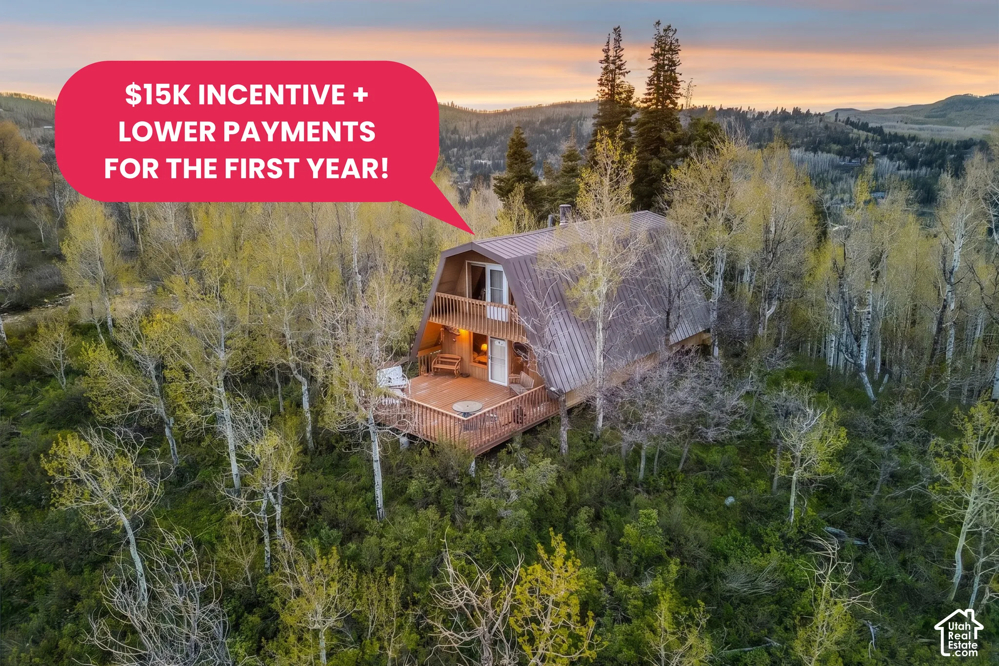 A-frame architecture with a metal roof, an upper-level balcony, a lower-level deck, and surrounded by mature trees