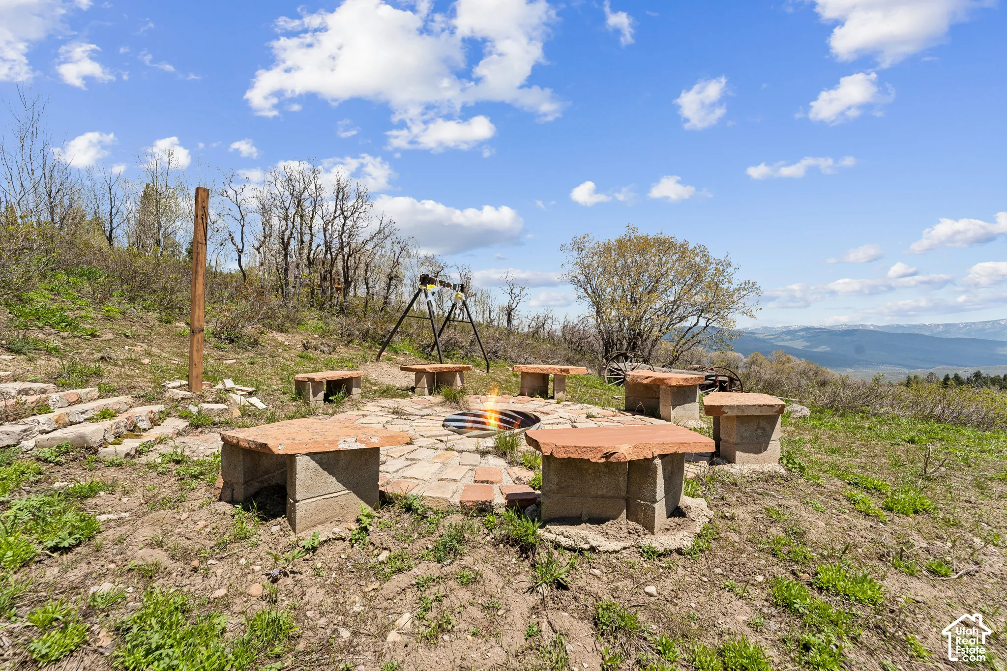 Fire Pit - Stone-set fire pit ringed with slab benches on a cleared rise above the valley.
