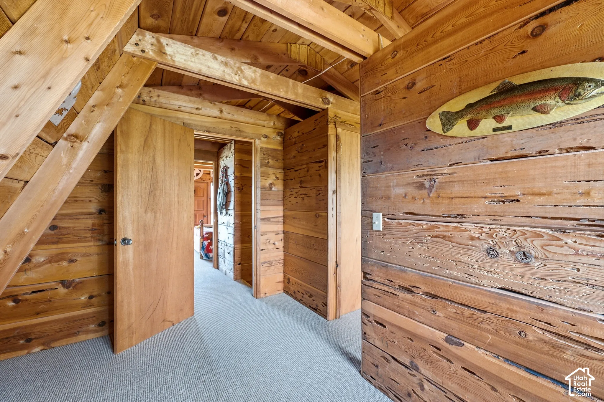 Upper Level Landing - Carpeted upper landing with pine paneling and interior doors to the upper bedrooms.
