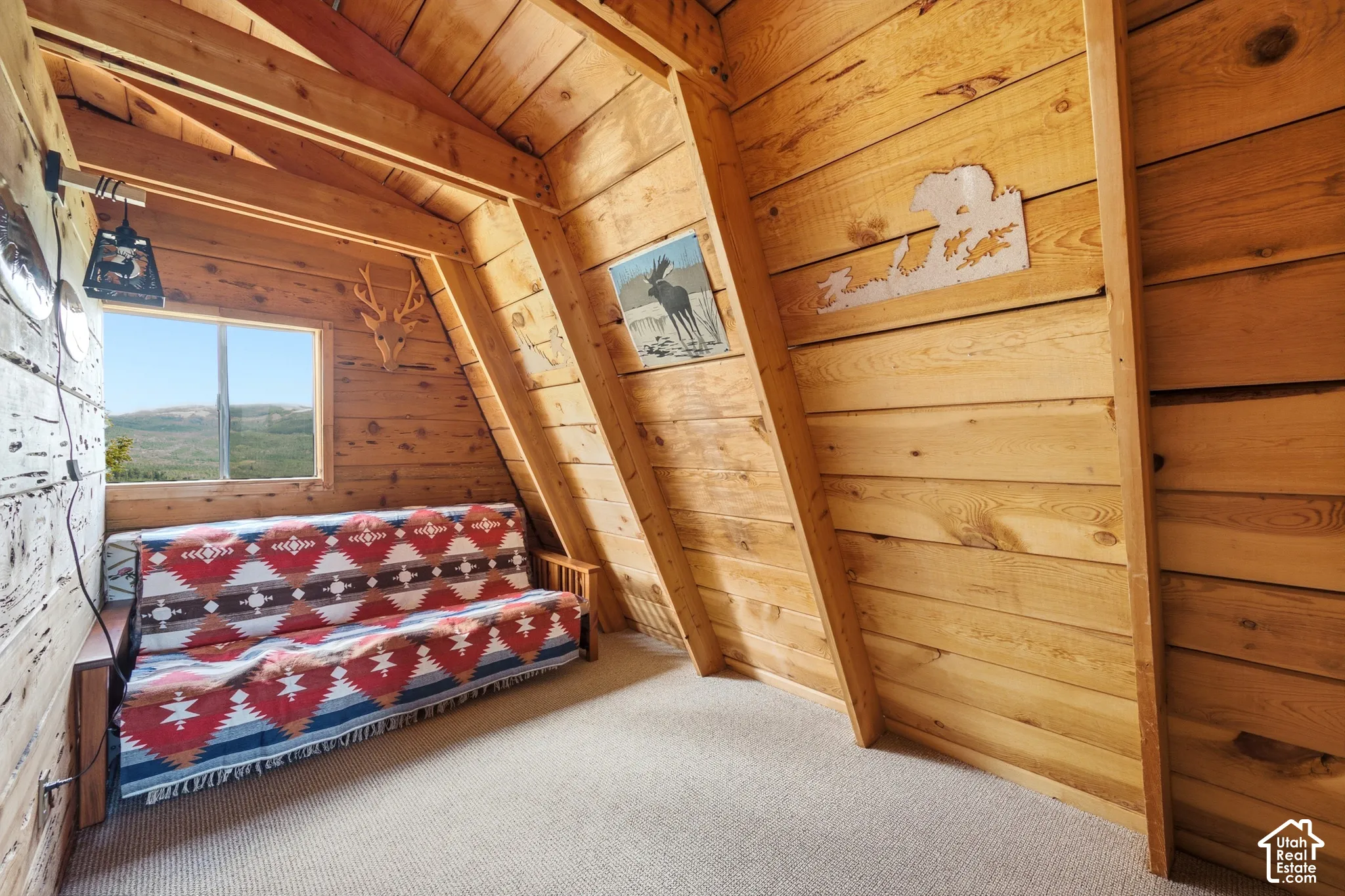 Second Bedroom - Additional angle showing the sleeping area, sloped walls, and mounted light fixtures.