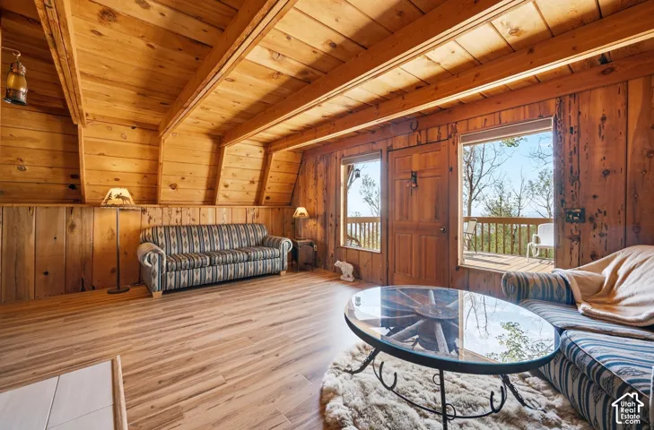 Living Room to Deck - Main living space with direct deck access and a wall of windows bringing in light and treetop views.