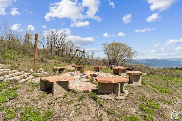 Fire Pit - Stone-set fire pit ringed with slab benches on a cleared rise above the valley.