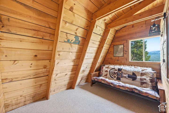 Upper Bedroom - Compact upper-level room with a window overlooking the valley and carpeted flooring throughout.
