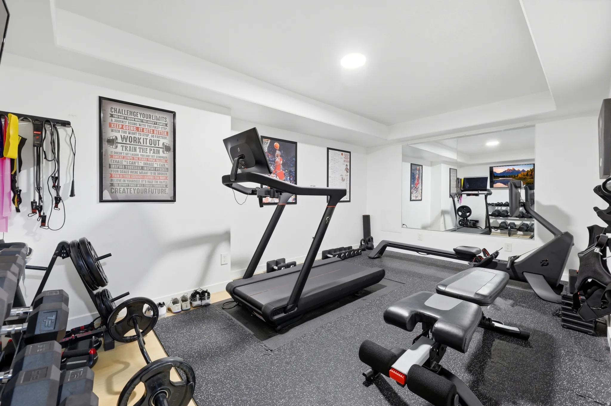 Dedicated exercise space featuring white walls and recessed lighting