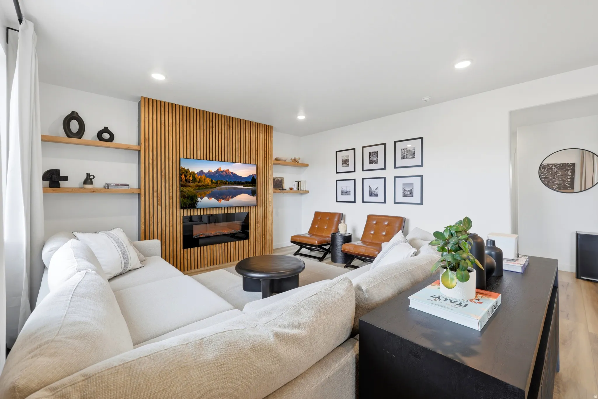 Bright living area featuring a slatted wood accent wall with an integrated linear fireplace