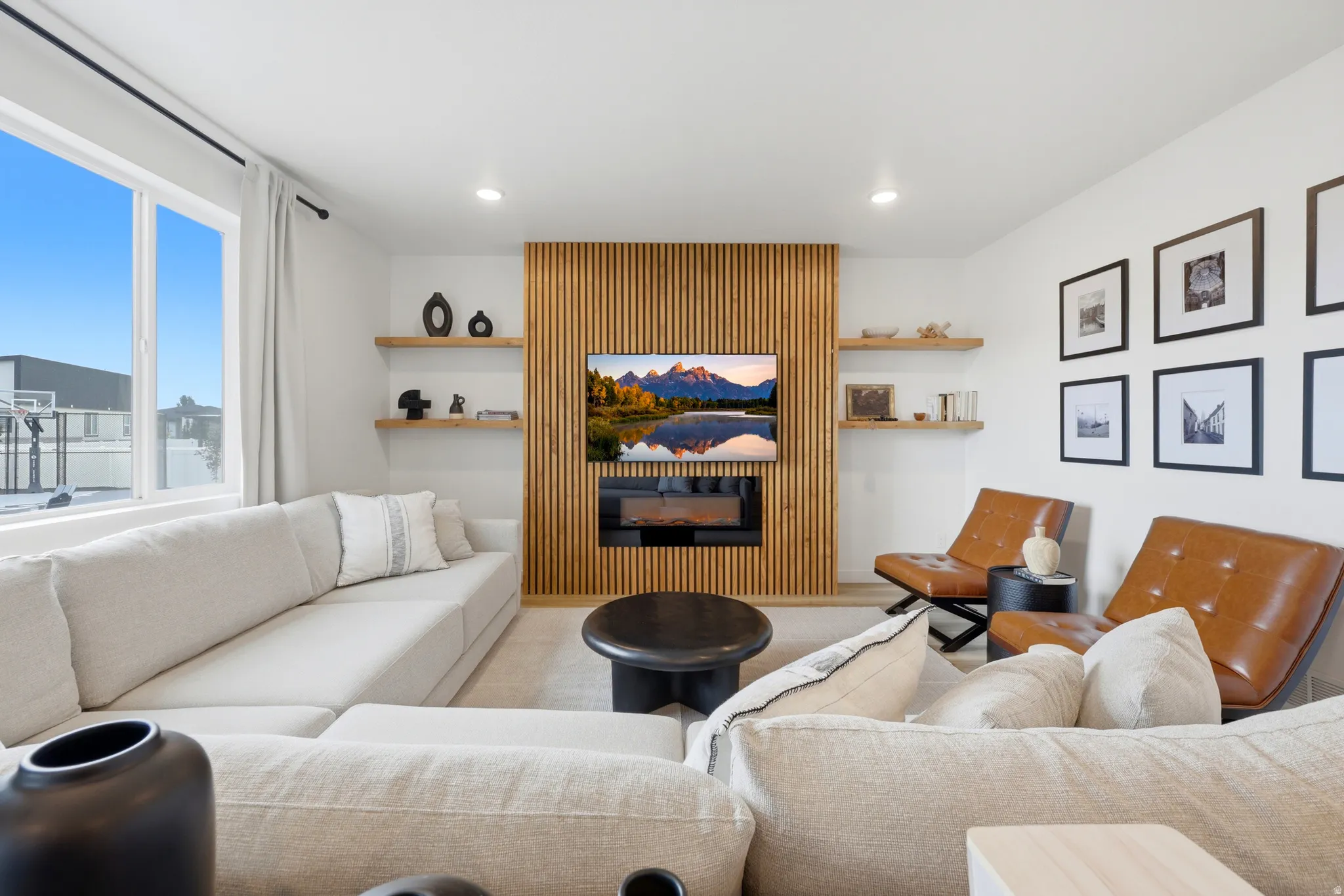 Living space featuring a vertical slat wood-finish accent wall with an integrated electric fireplace