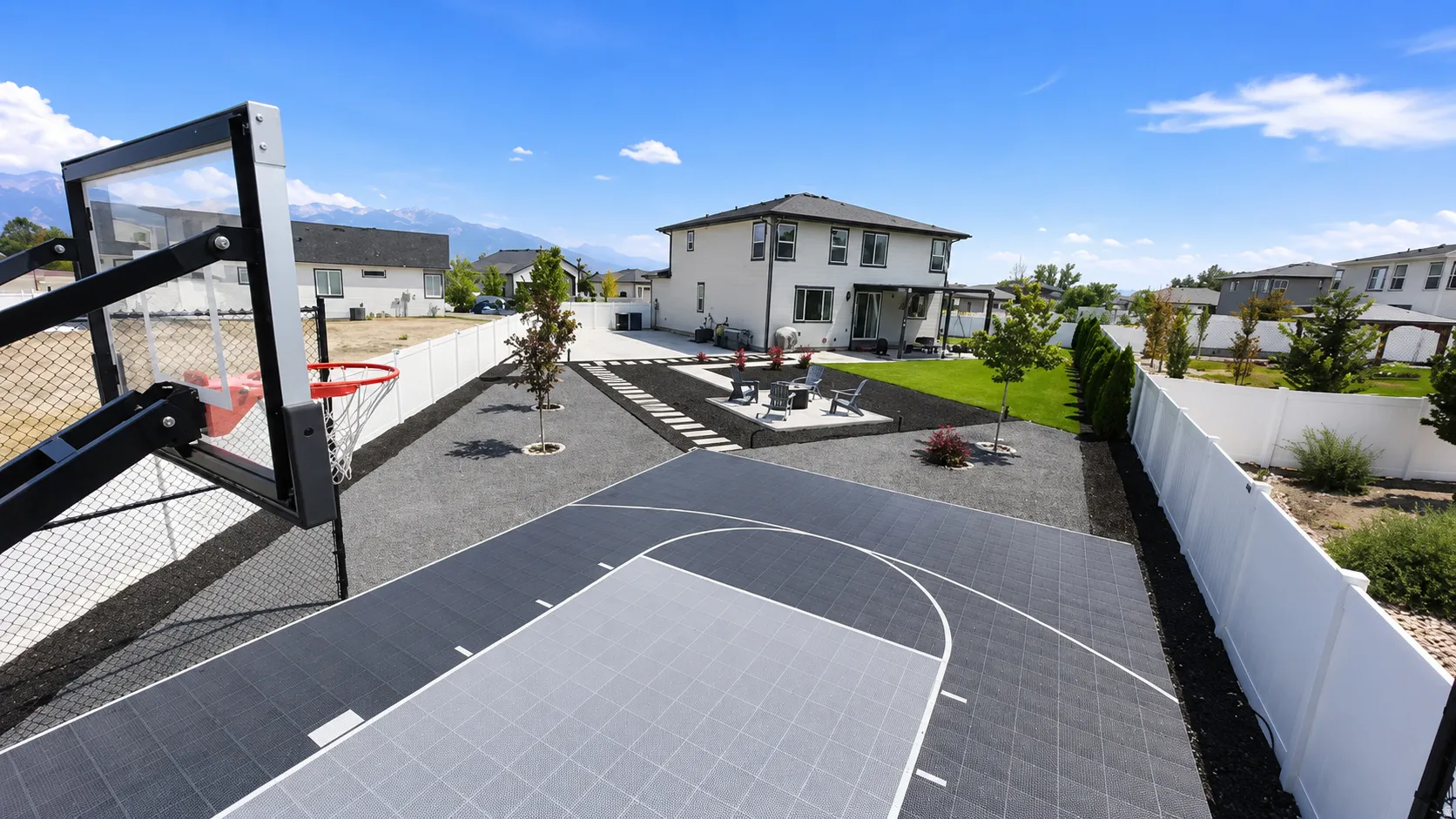 Outdoor sports court featuring a basketball hoop with a clear backboard