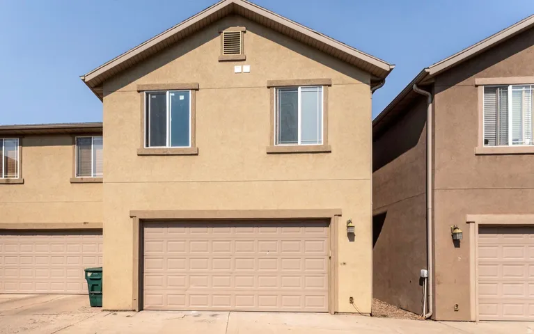 Contemporary stucco exterior featuring a two-story design with a prominent front-facing gable