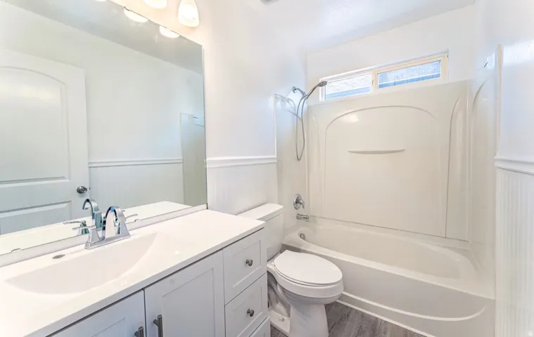 Bright and spa-like primary bathroom featuring a spacious double vanity with ample storage, white quartz countertops, and chrome faucetry