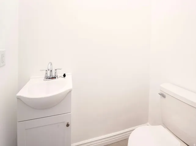 White pedestal sink with chrome faucet