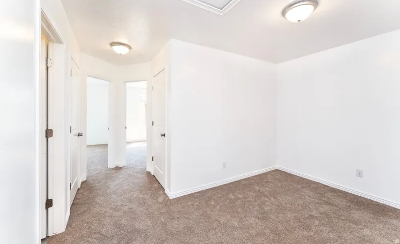 Spacious bedroom featuring neutral wall finishes, recessed ceiling lighting, and carpet flooring