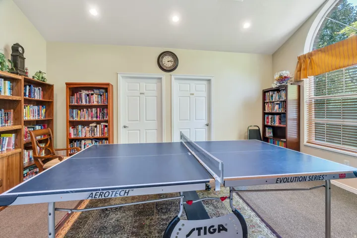 Recreation room with vaulted ceilings and recessed lighting