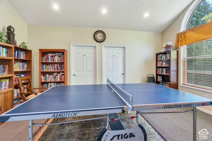 Recreation room with vaulted ceilings and recessed lighting
