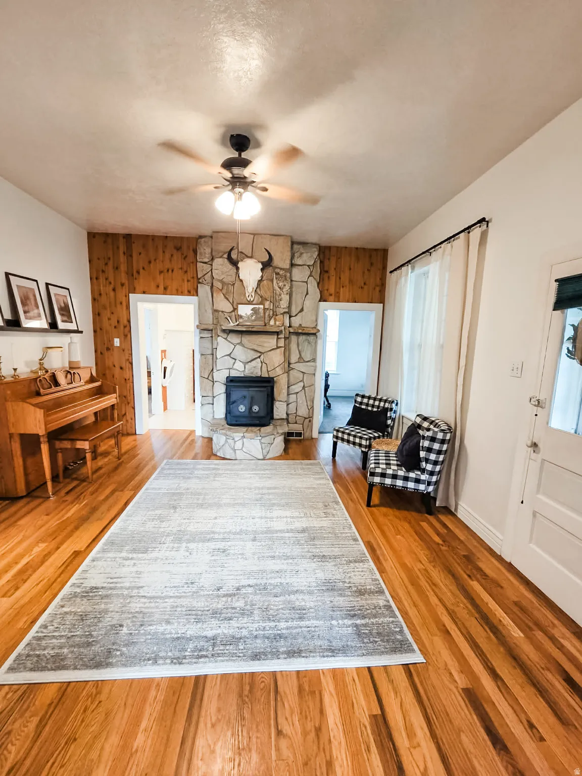 large living room with wood rocked fireplace