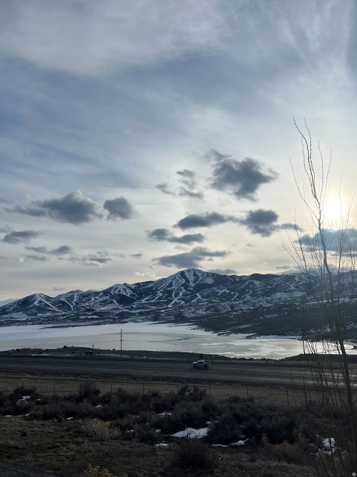 Mountain range with snow-capped peaks overlooking a frozen body of water
