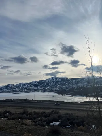 Mountain range with snow-capped peaks overlooking a frozen body of water