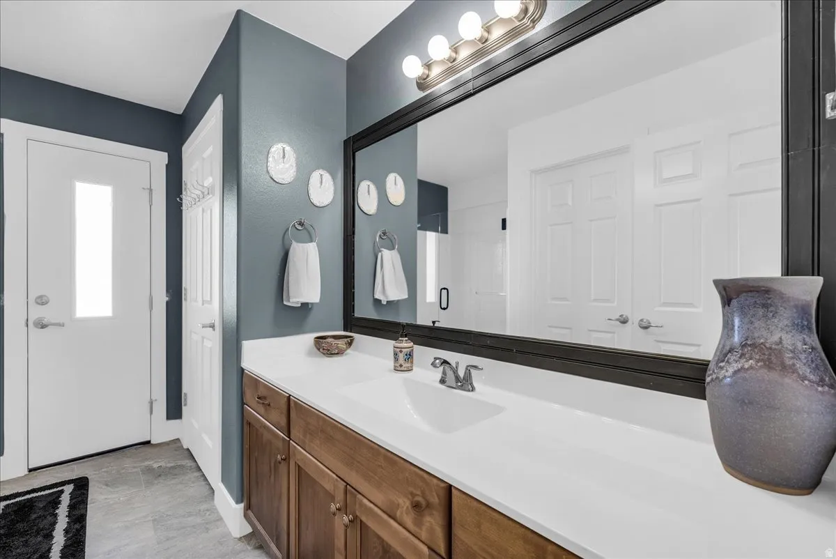 Spacious vanity featuring an integrated sink, polished chrome faucet, and wood-finish cabinetry