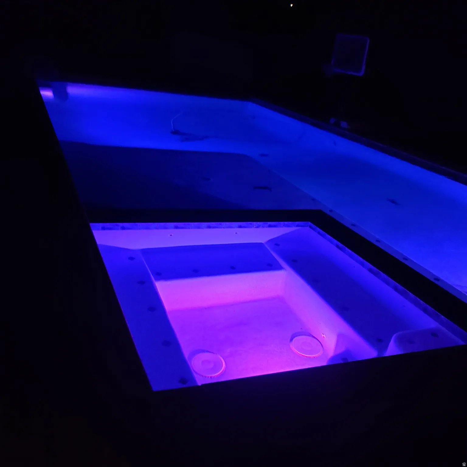 Pool and spa combination featuring interior lighting