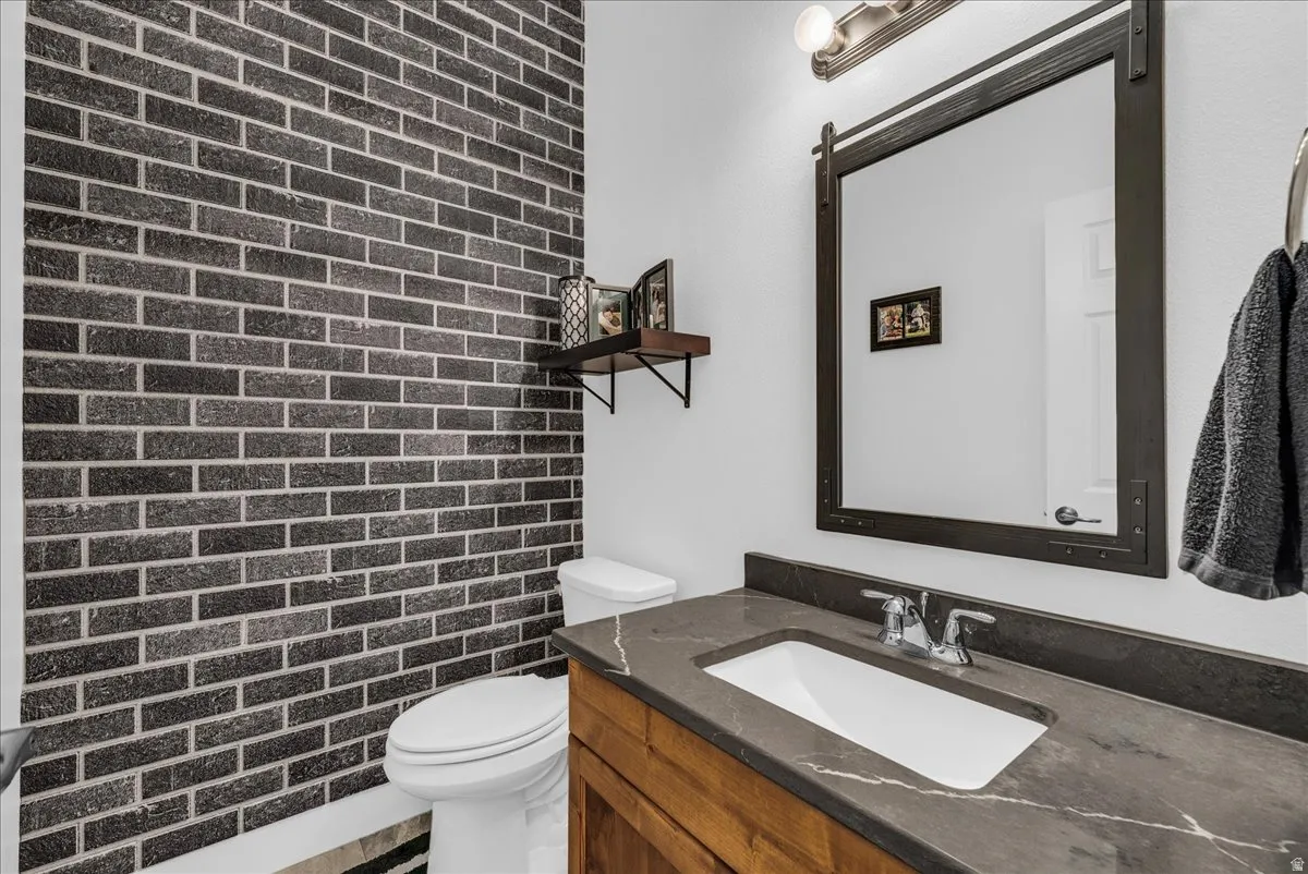 Accent wall featuring dark brick-style tile