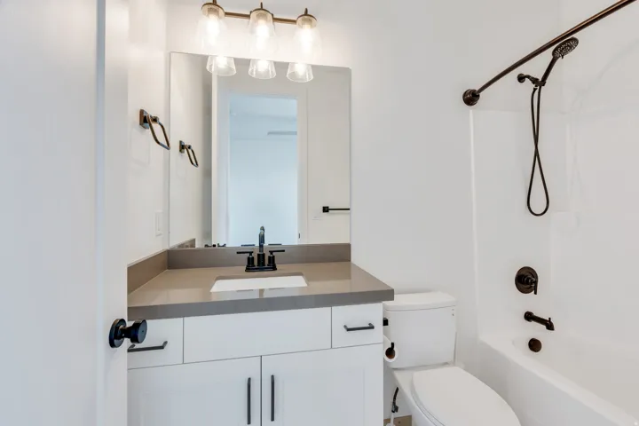 White shaker vanity with a light gray countertop and undermount sink